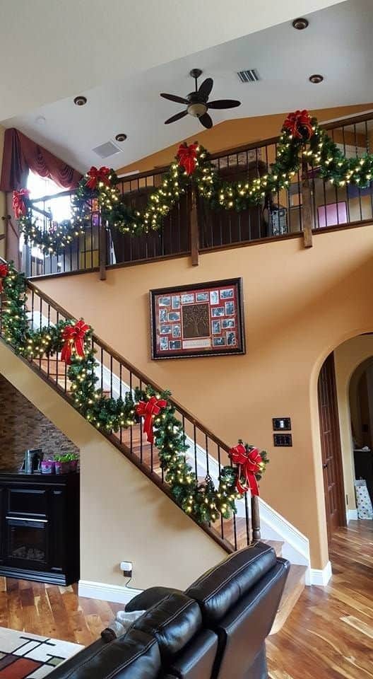 Lit garlands with red Ribbons on Balcony Banister