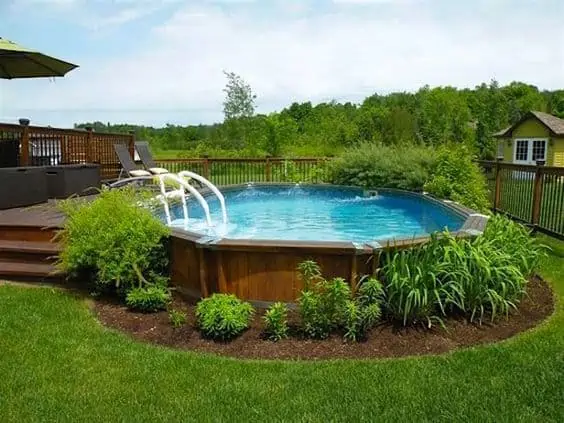 secluded pool with vegetation and a deck